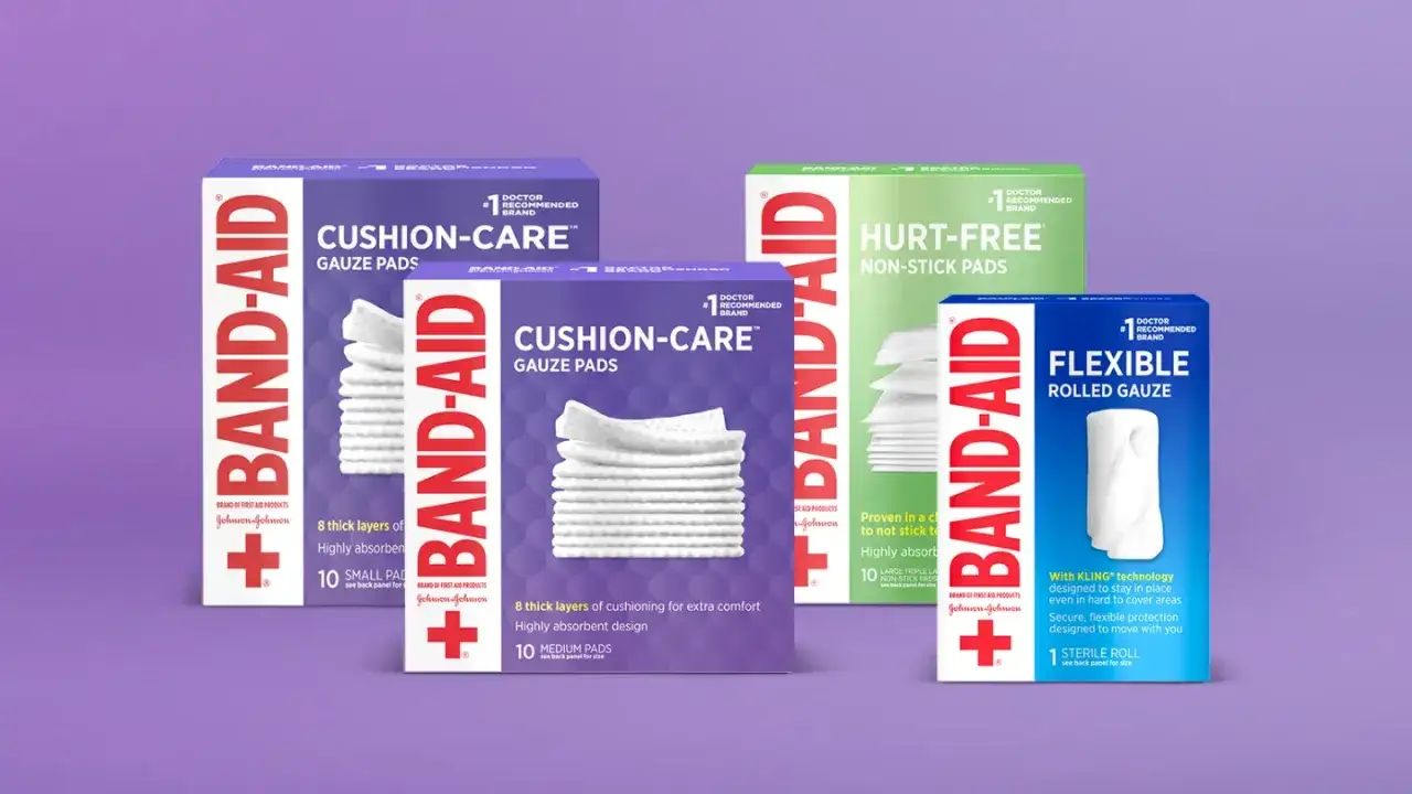 Opakowania opatrunków Band-Aid: podkładki gazowe Cushion-Care, podkładki Hurt-Free i elastyczna gaza.